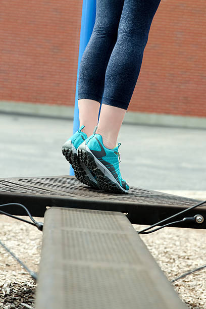 istock young fitness woman runner stretching legs before run 545672068
