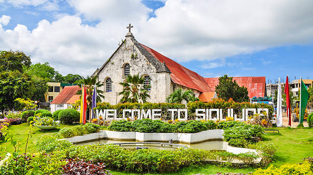 Welcome Sign, City of Siquijor, Philippines City of Siquijor welcome sign, behind which is the Spanish colonial era church Saint Francis of Assisi - Philippines. siquijor stock pictures, royalty-free photos & images