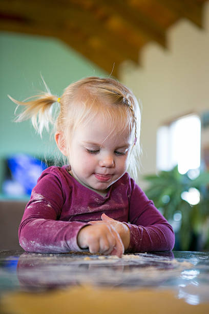 istock Cute little blond girl baking 545676380