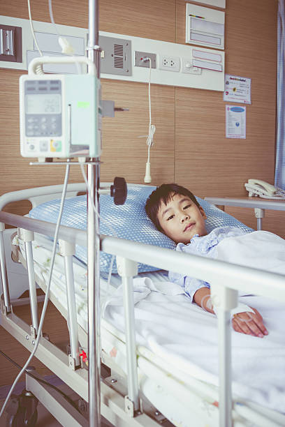 istock Asian boy lying with infusion pump intravenous IV drip 545676834