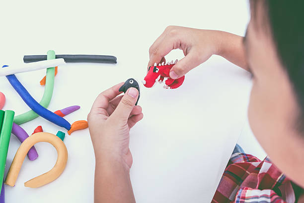 istock Funny asian child playing with clay, on white background. 545677960