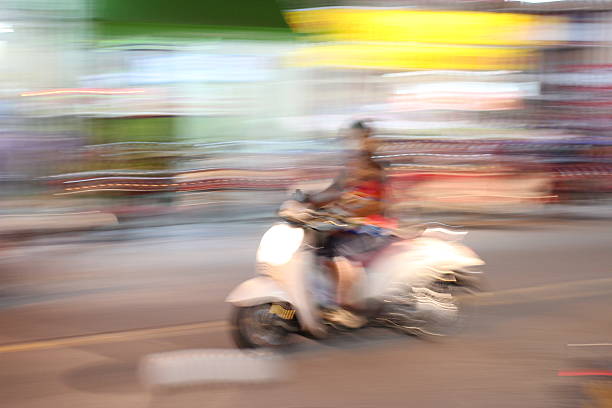 istock Street lights in speeding Motorcycle driver at night time, 545679838