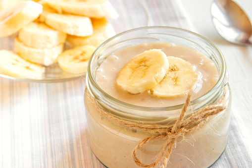 Banana mousse (pudding) for healthy vegetarian dessert over white background