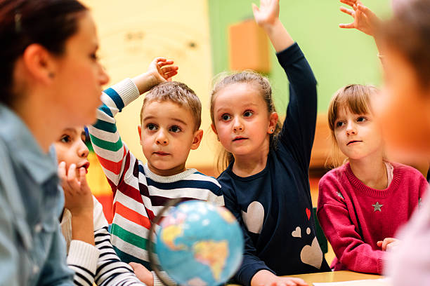 istock Preschool teacher and children in classroom 545773892