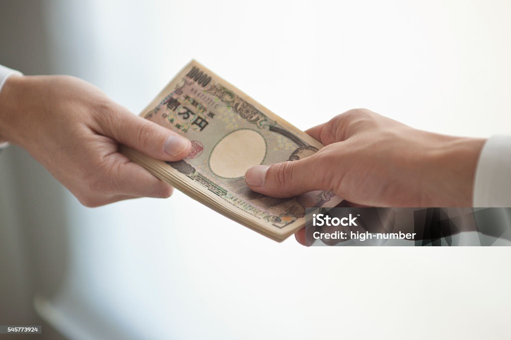 Businessman's hand that presents bank notes Businessman's hand holding out banknotes Currency Stock Photo
