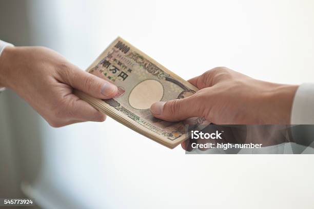 Businessmans Hand That Presents Bank Notes Stock Photo - Download Image Now - Currency, Giving, Passing - Giving