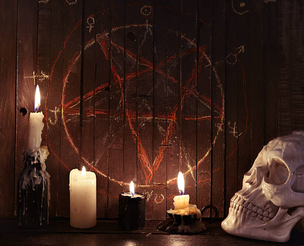 istock Evil candles against wooden background with pentagram 545774878