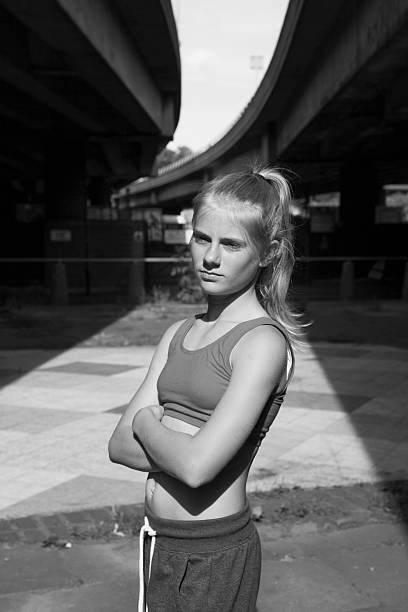 istock girl standing under urban flyover bridge 545776328
