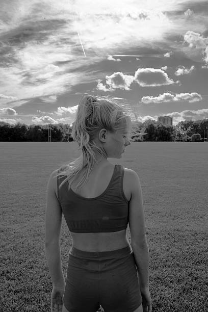 istock girl standing against dramatic sky background 545779044