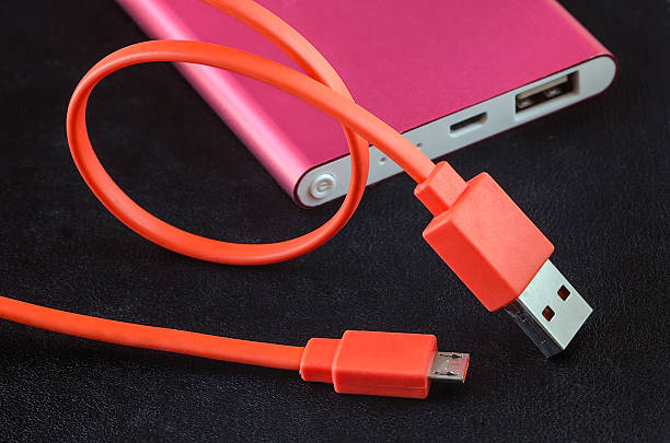 istock Orange color USB cable and red power bank 545779790