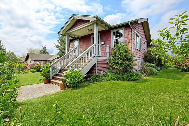 istock Big farmhouse with beautiful flowerbed, concrete walkway 545780084