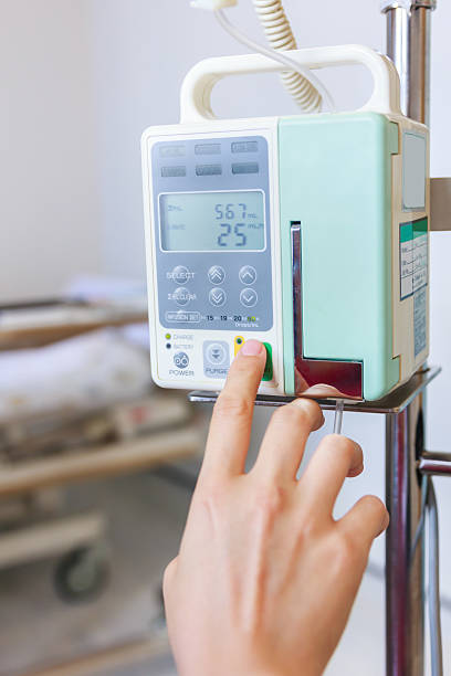 istock Nurse's hands regulation infusion pump intravenous IV drip. 545780888