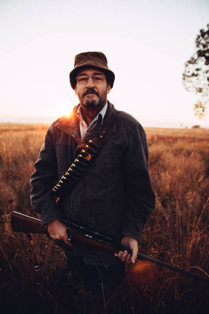 istock Hunter smiling and looking at camera carrying his rifle 545782650