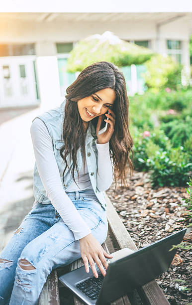 istock beautiful young woman using laptop 545783034