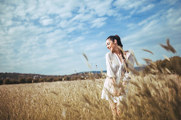 istock Pretty young woman in field at sunset 545784614