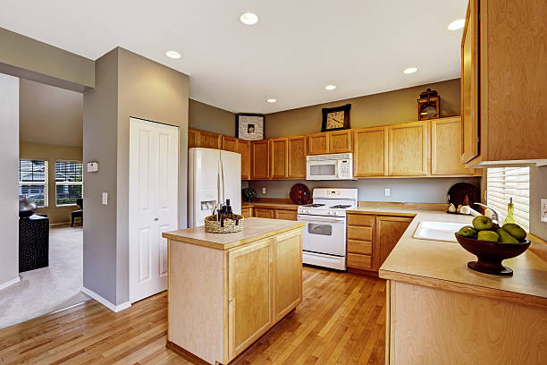 istock Kitchen interior with brown cabinets, hardwood floor 545785432