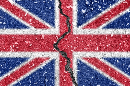 Brexit - British flag painted on the tarmac cracked on the middle