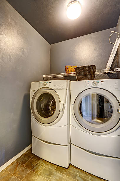 istock Laundry room with tile floor, washer, and dryer. 545786444