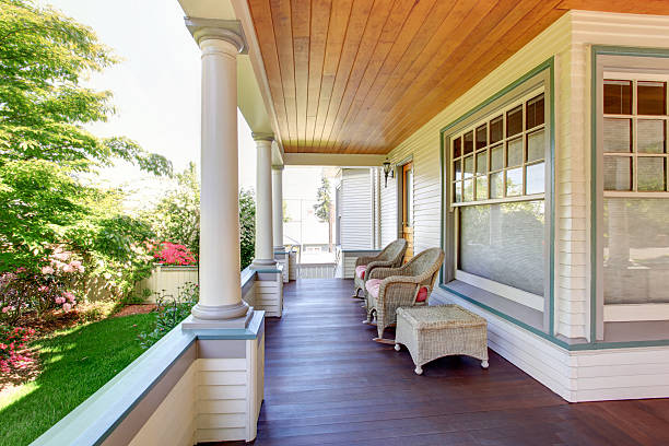 istock Front porch with chairs and columns of craftsman home. 545788280