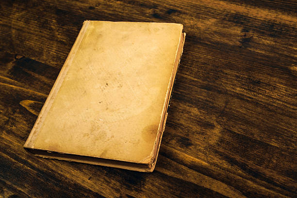 istock Old vintage book on rustic wooden table 545788842