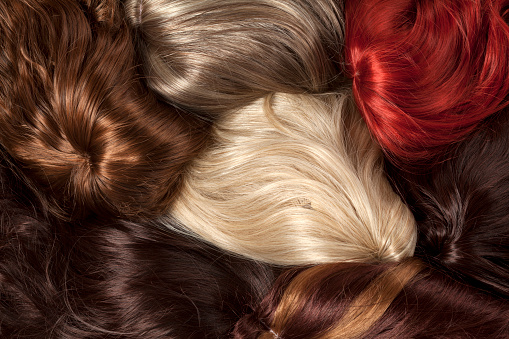 bunch of wigs in different colors