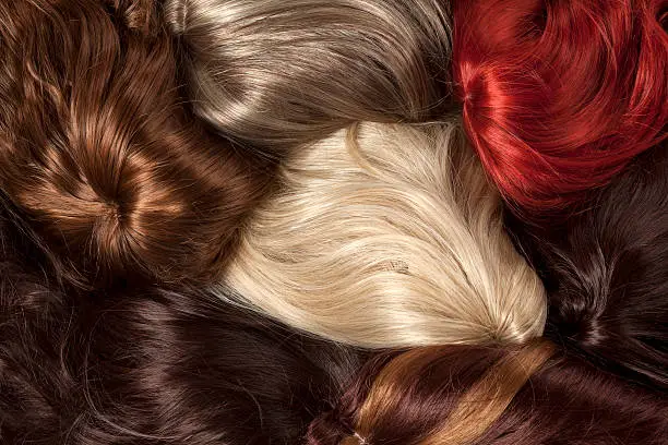 bunch of wigs in different colors