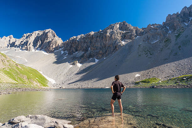 istock Hiker relaxing at alpine lake, summertime on the Alps 545790932