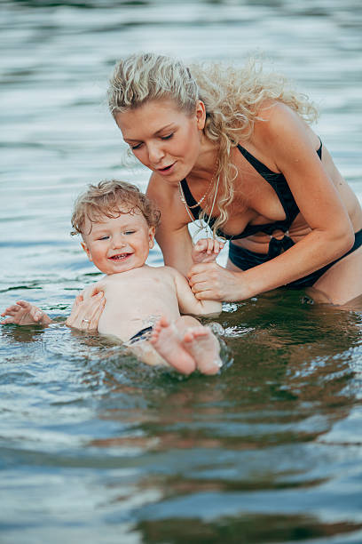 istock young mother with her son in water 545791376