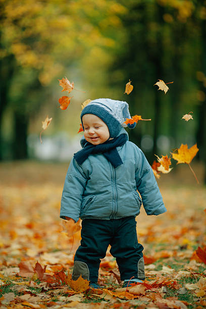 istock little boy in autumn park 545793412