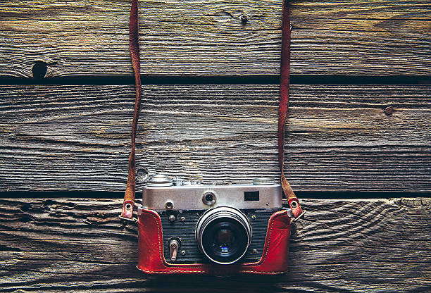 istock Retro camera on wood table background, vintage color tone 545795556