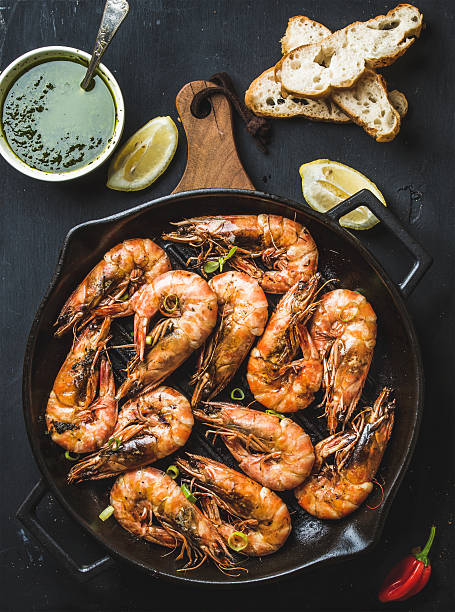 istock Roasted tiger prawns in iron grilling pan on wooden board 545799306