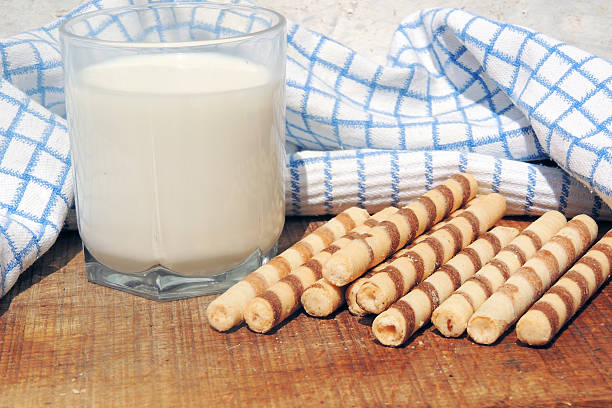istock Milk and waffle rolls on wooden Board 545801592