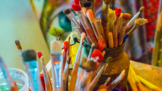 Brushes colors in painting studio