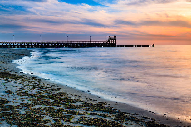 istock Coast with piles during sunset, long exposure blurring water.Baltic, Poland. 545802690