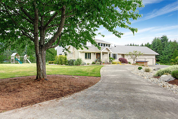 istock Large beige house with white trim, and well kept lawn 545803474