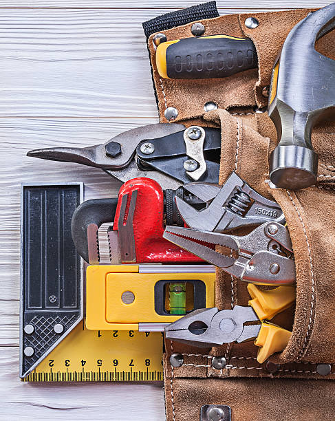 istock Leather toolbelt building implements on wood board construction 545803714