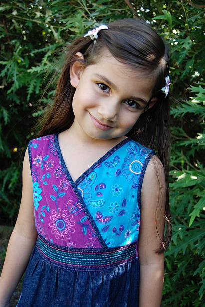 istock Dark haired beautiful little girl making faces 545804036