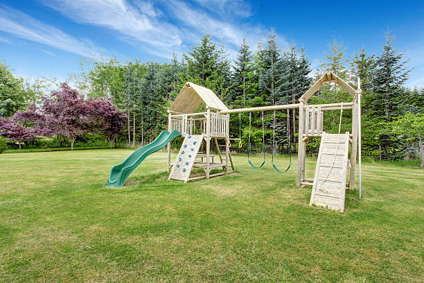 istock Backyard playground with swings, climbing wood panel 545805002
