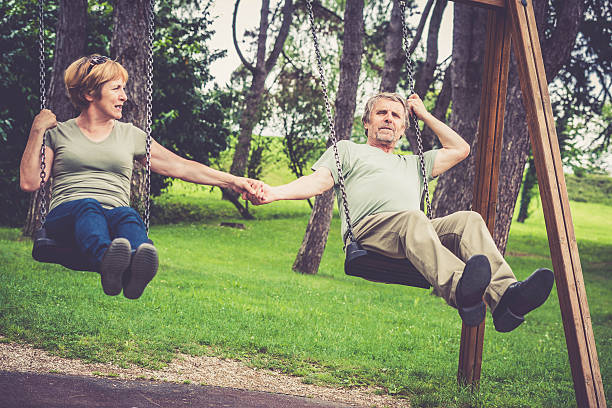 istock Senior caucasian couple swinging outdoors and holding hands 545805138