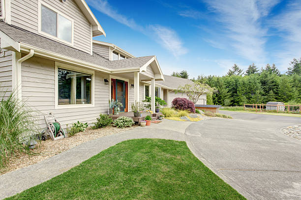 istock Large beige house with white trim, and well kept lawn 545805390