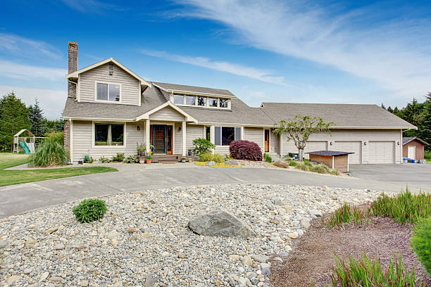 istock Large beige house with white trim, and well kept lawn 545805470