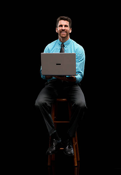 istock Smiling businessman working on laptop 545805862