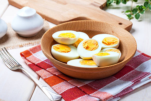 istock Half-boiled eggs in a wooden bowl. 545806738