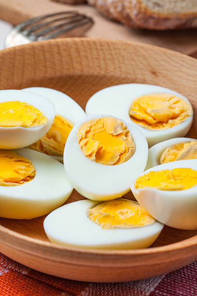 istock Half-boiled eggs in a wooden bowl. 545806934