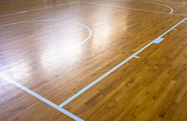 istock wooden floor basketball court with light effect 545807416