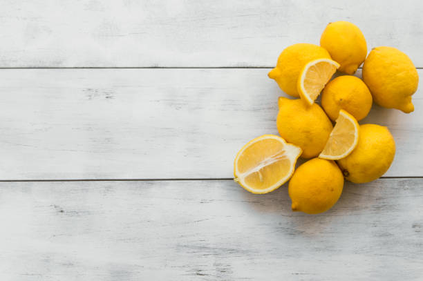 istock fresh ripe lemons on white wooden table 545811782