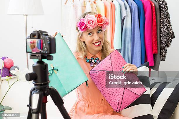 Fashion Blogger Taking Picture And Holding Two Clutch Bags Stock Photo - Download Image Now