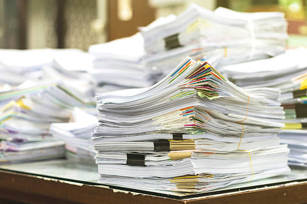 istock Pile of documents with colorful clips on desk stack up 545814346