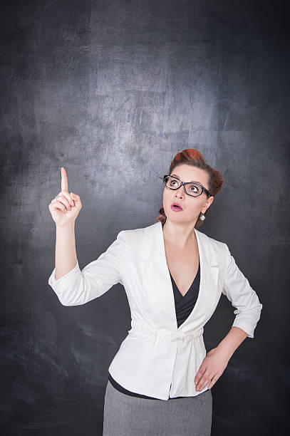 istock Teacher showing on something by finger 545816058