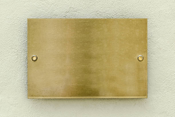 Golden plaque Golden plaque on a wall for your background plaque stock pictures, royalty-free photos & images